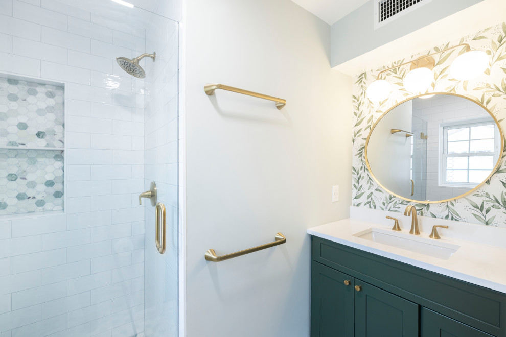 This is an example of a medium sized contemporary ensuite bathroom in DC Metro with shaker cabinets, green cabinets, an alcove shower, white tiles, ceramic tiles, green walls, marble flooring, a submerged sink, engineered stone worktops, green floors, a hinged door, white worktops, a wall niche, a single sink, a built in vanity unit and wallpapered walls.