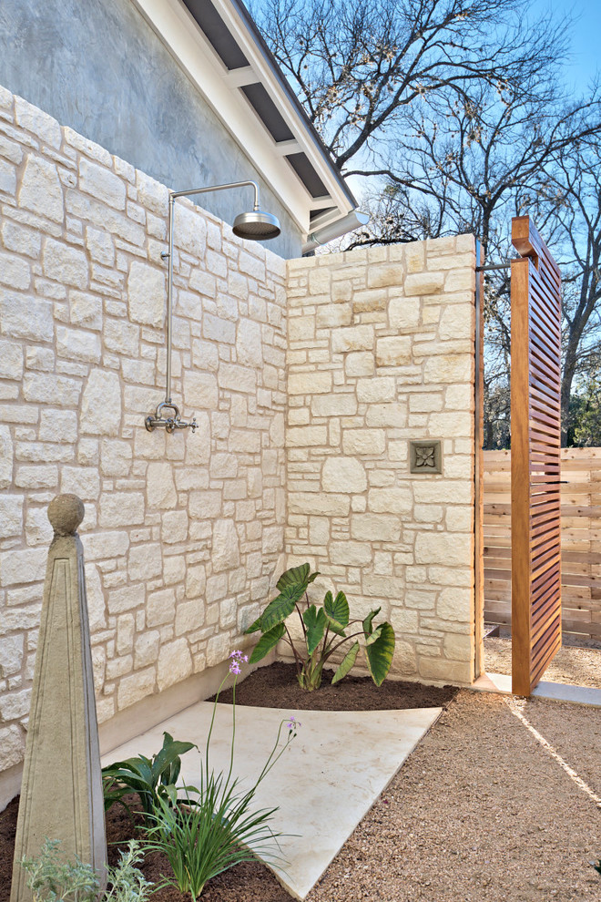 Inspiration for a large transitional courtyard patio in Austin with an outdoor shower and decomposed granite.