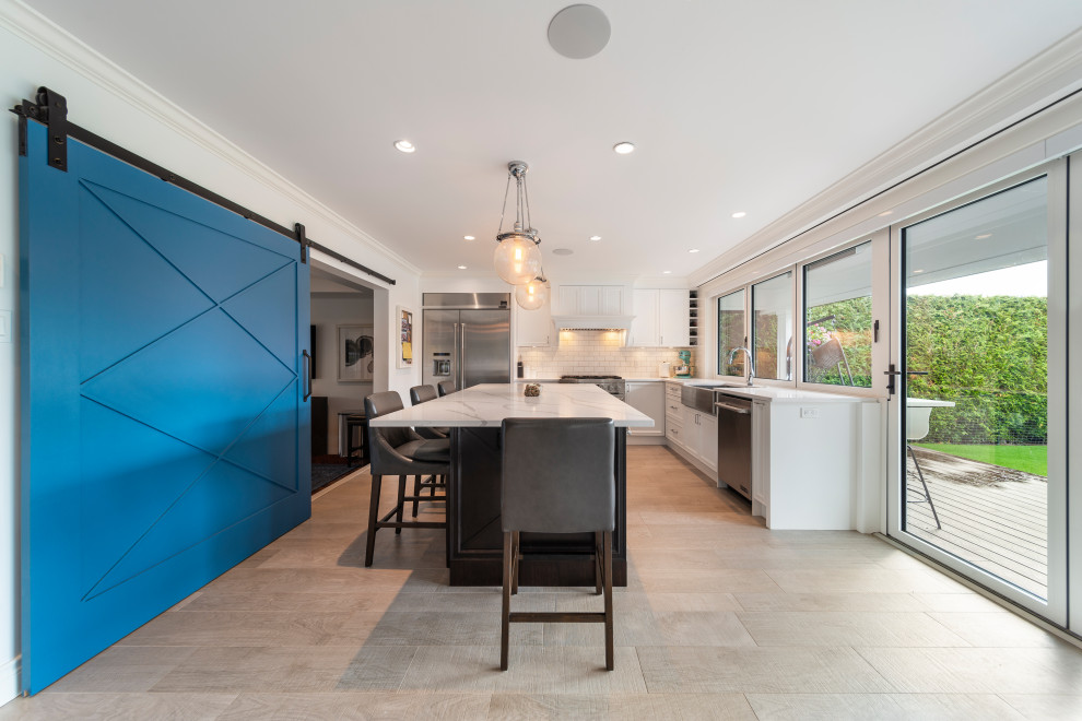 Inspiration for a transitional beige floor kitchen remodel in Vancouver with white backsplash, stainless steel appliances, an island and white countertops