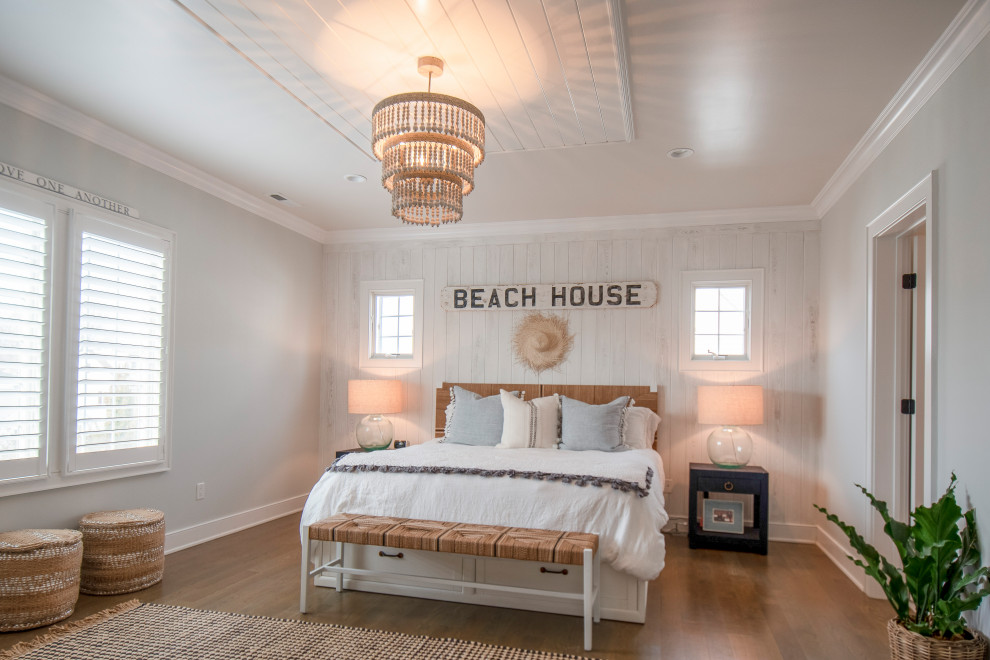 Large beach style guest light wood floor, brown floor, shiplap ceiling and wood wall bedroom photo in Other with white walls and no fireplace