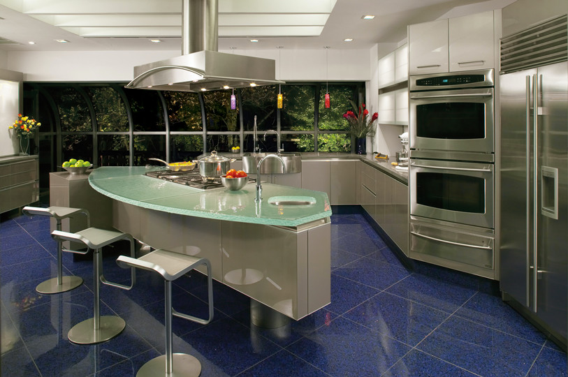 Photo of a large modern l-shaped eat-in kitchen in New York with a double-bowl sink, glass-front cabinets, concrete benchtops, white splashback, glass sheet splashback, stainless steel appliances, grey cabinets, marble floors and with island.
