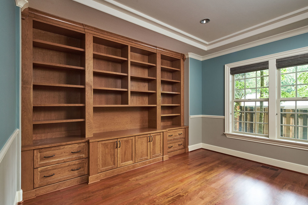 Inspiration för ett stort lantligt arbetsrum, med ett bibliotek, blå väggar, mellanmörkt trägolv och brunt golv