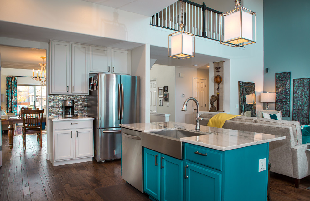 Mid-sized transitional l-shaped dark wood floor and brown floor open concept kitchen photo in Denver with a farmhouse sink, shaker cabinets, white cabinets, marble countertops, metallic backsplash, matchstick tile backsplash, paneled appliances, an island and gray countertops