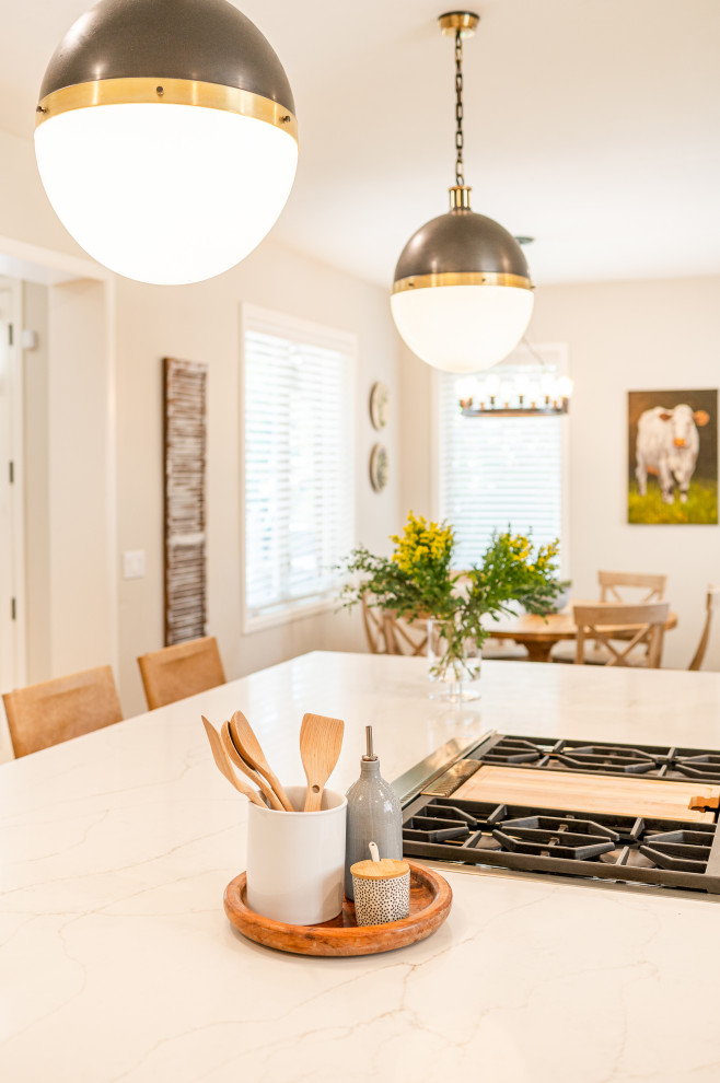 Inspiration for a large transitional l-shaped dark wood floor and brown floor open concept kitchen remodel in Denver with a farmhouse sink, shaker cabinets, beige cabinets, quartz countertops, beige backsplash, ceramic backsplash, stainless steel appliances, an island and white countertops