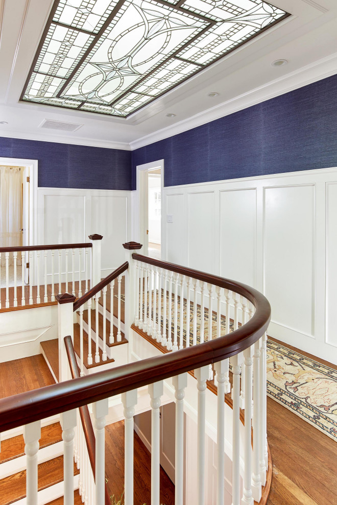 Photo of a large traditional hallway in San Francisco with medium hardwood floors, brown floor, decorative wall panelling, wallpaper, white walls and coffered.