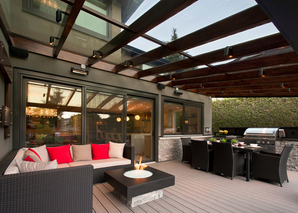 Design ideas for a large contemporary backyard deck in Vancouver with a pergola.