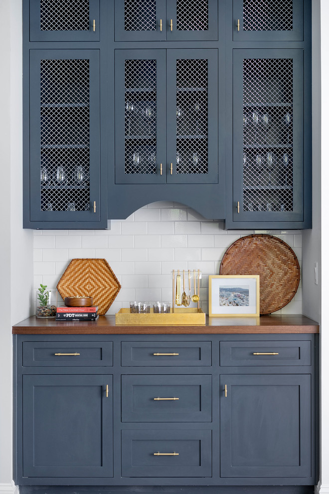 Inspiration for a beach style single-wall wet bar in Jacksonville with beaded inset cabinets, blue cabinets, wood benchtops, red splashback and brown benchtop.