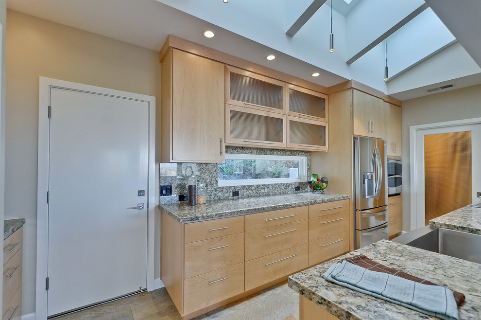 This is an example of a large midcentury galley separate kitchen in San Francisco with a farmhouse sink, flat-panel cabinets, light wood cabinets, granite benchtops, grey splashback, stone slab splashback, stainless steel appliances, slate floors, no island and multi-coloured floor.