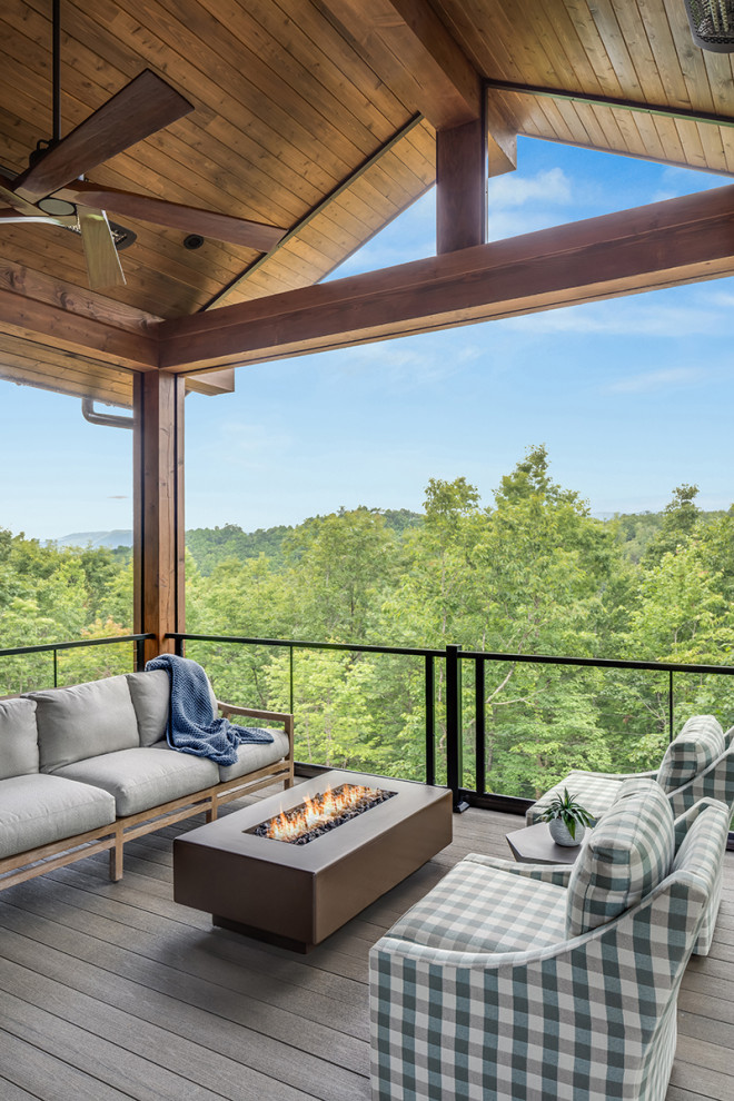 Large transitional backyard screened-in and cable railing deck photo with decking and a roof extension