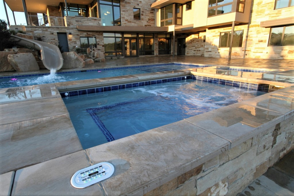 Large backyard rectangular water slide photo in Denver