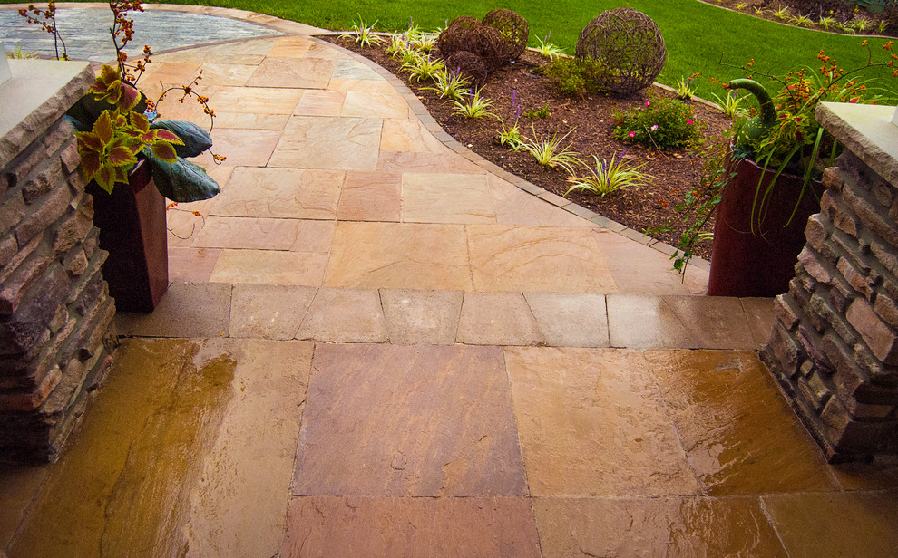 Design ideas for a transitional front yard stone garden path in St Louis for fall.