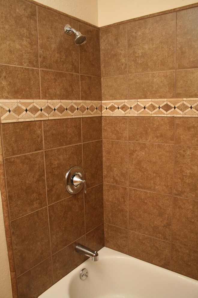 Photo of a mid-sized traditional master bathroom in Other with ceramic tile, beige walls, dark wood cabinets, a corner tub, a corner shower, pebble tile floors, grey floor and a hinged shower door.