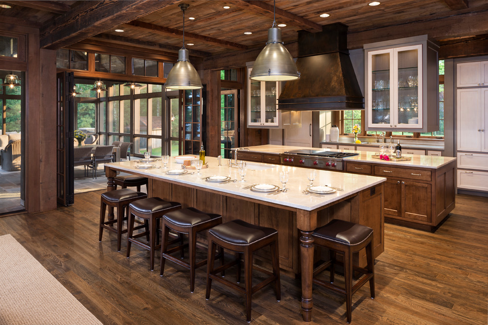 Design ideas for a country kitchen in Denver with shaker cabinets, dark wood cabinets, stainless steel appliances, dark hardwood floors and multiple islands.