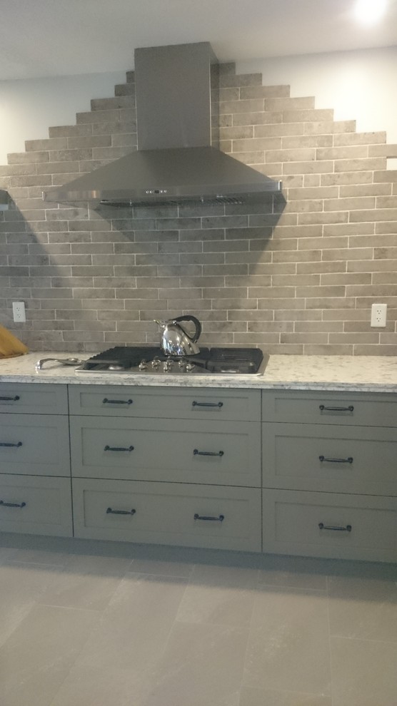 Inspiration for a mid-sized transitional l-shaped porcelain tile eat-in kitchen remodel in Toronto with a double-bowl sink, shaker cabinets, gray cabinets, quartz countertops, multicolored backsplash, porcelain backsplash, stainless steel appliances and an island