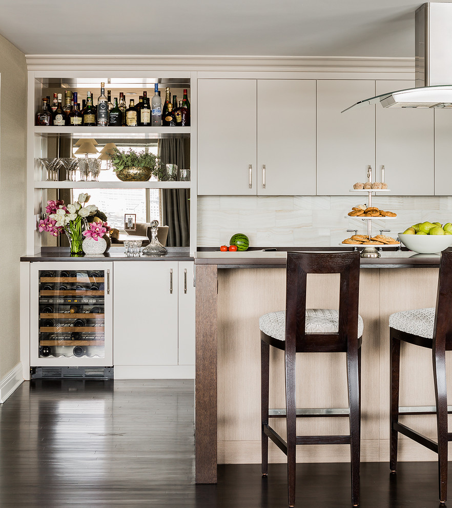 Eat-in kitchen - mid-sized transitional single-wall dark wood floor eat-in kitchen idea in Boston with flat-panel cabinets, gray cabinets, white backsplash, stone tile backsplash, stainless steel appliances and an island