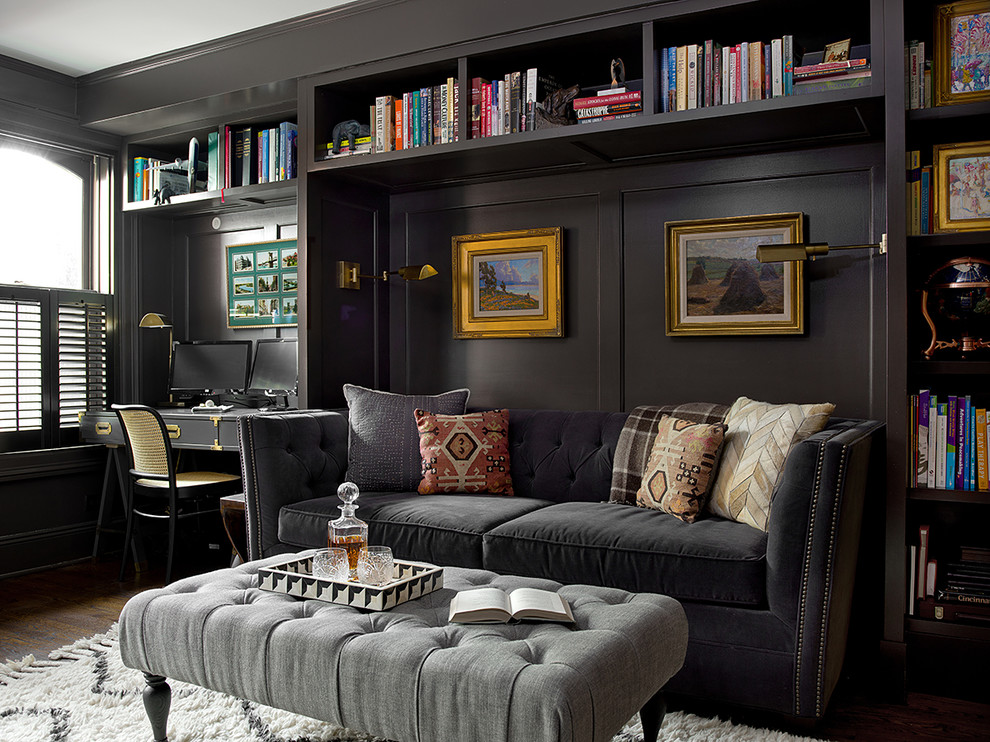 Photo of a transitional family room in Chicago with a library, black walls, dark hardwood floors and brown floor.