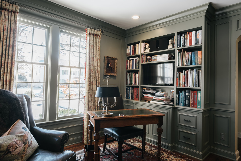 Design ideas for a mid-sized traditional study room in Minneapolis with dark hardwood floors, a standard fireplace, a wood fireplace surround, a freestanding desk and grey walls.