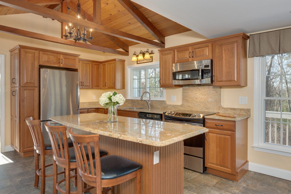 Design ideas for a large traditional l-shaped eat-in kitchen in Boston with an undermount sink, raised-panel cabinets, medium wood cabinets, granite benchtops, stainless steel appliances and with island.