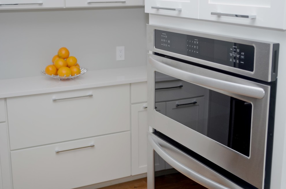 Large transitional eat-in kitchen photo in Los Angeles with an undermount sink, shaker cabinets, quartz countertops, stainless steel appliances, two islands and white cabinets