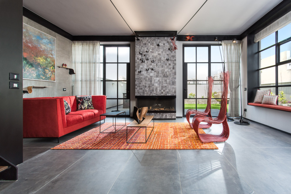 Photo of a mid-sized industrial formal living room in Tel Aviv with grey walls, porcelain floors, a ribbon fireplace, no tv, grey floor and a tile fireplace surround.