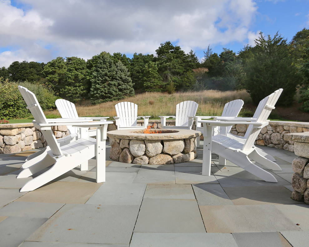Design ideas for a country patio in Boston with natural stone pavers.