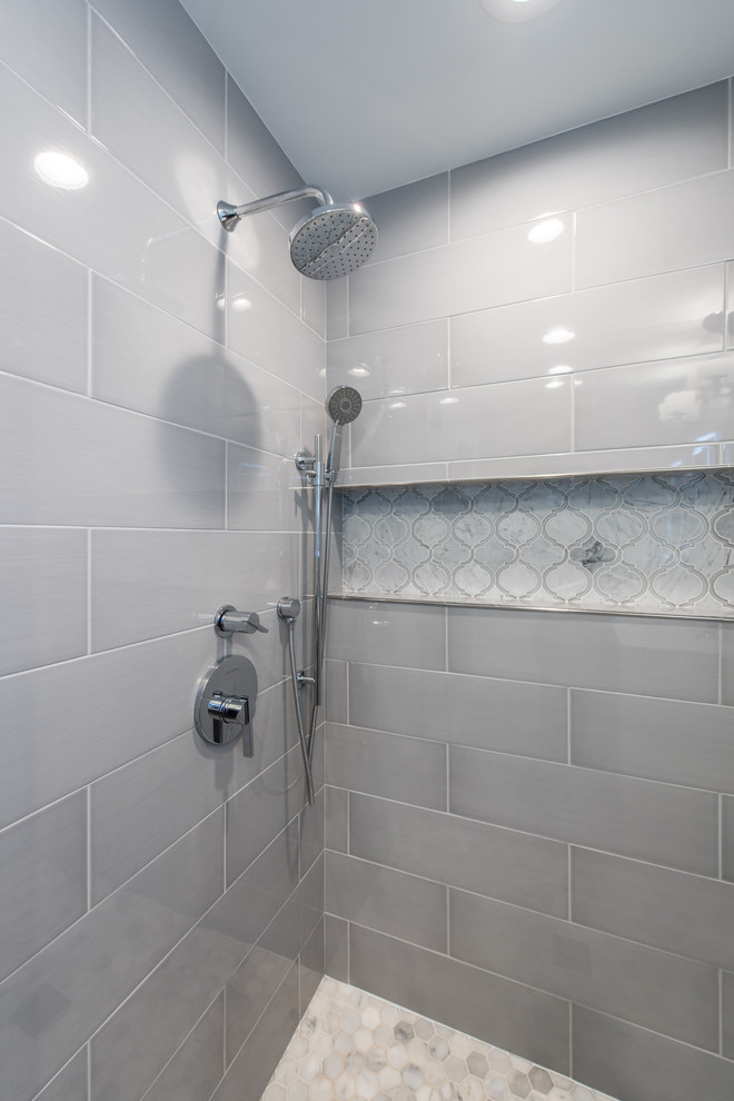 This is an example of a small contemporary master bathroom in DC Metro with flat-panel cabinets, distressed cabinets, a double shower, gray tile, subway tile, grey walls, marble floors, a console sink, solid surface benchtops, grey floor and a hinged shower door.