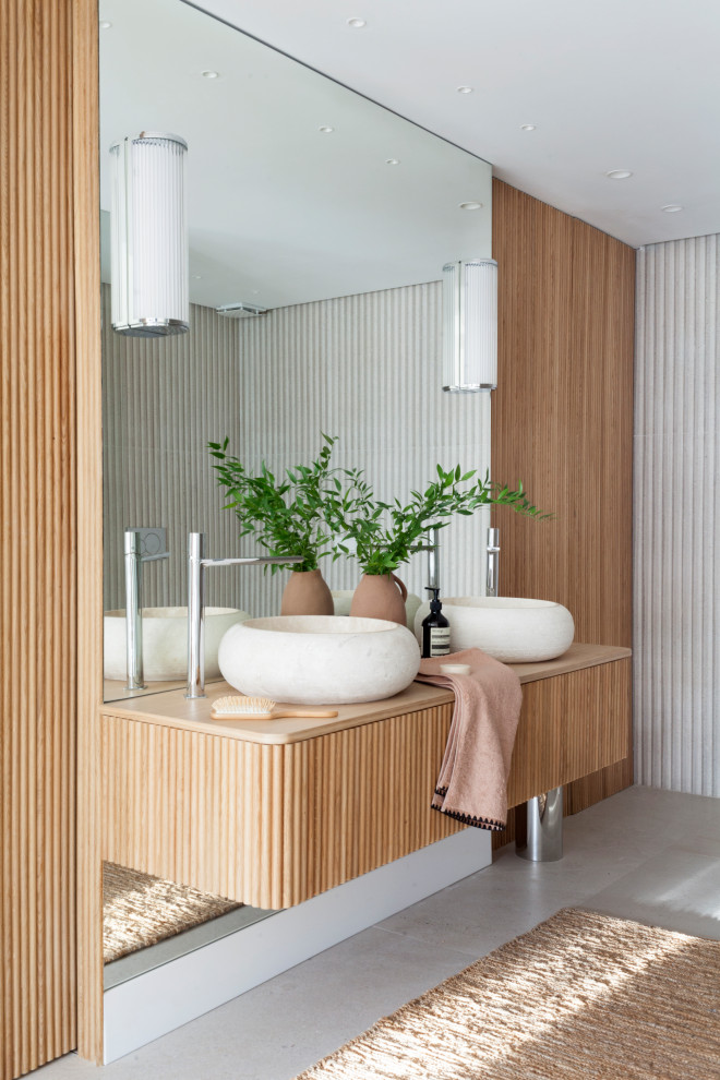 Inspiration for an expansive contemporary master bathroom in Valencia with a curbless shower, beige tile, ceramic tile, beige walls, ceramic floors, a vessel sink, wood benchtops, beige floor, a double vanity, a built-in vanity and flat-panel cabinets.