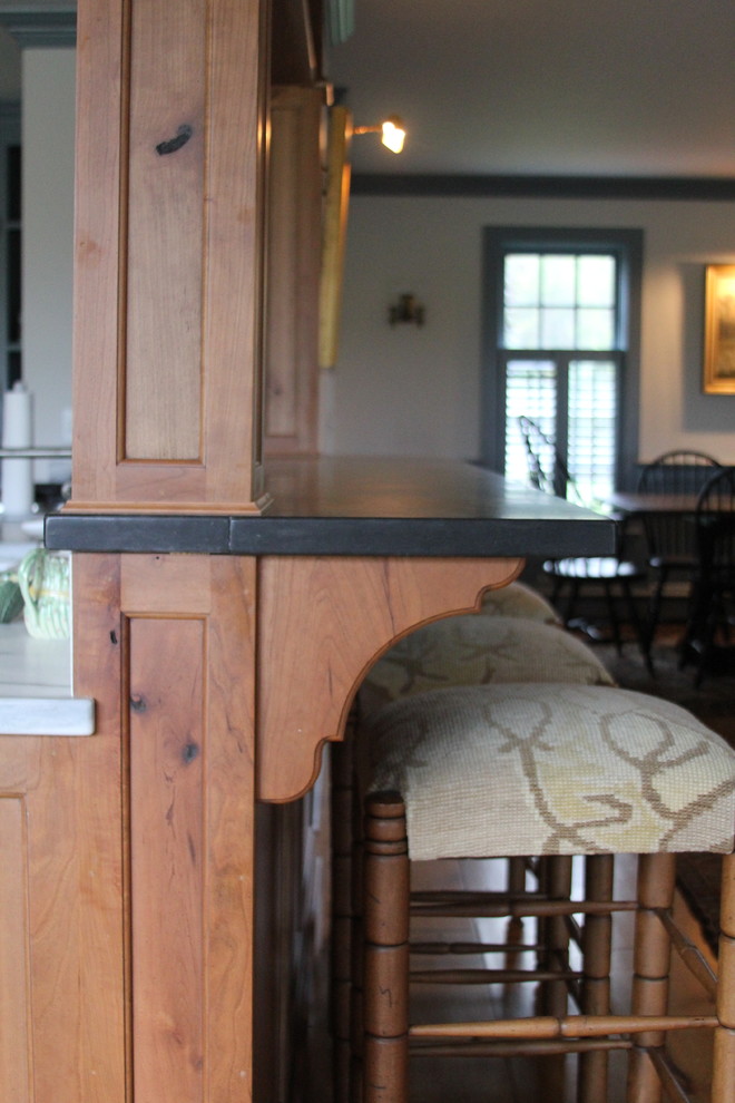Example of a large transitional galley eat-in kitchen design in Boston with raised-panel cabinets, medium tone wood cabinets, marble countertops, stainless steel appliances, a farmhouse sink and a peninsula
