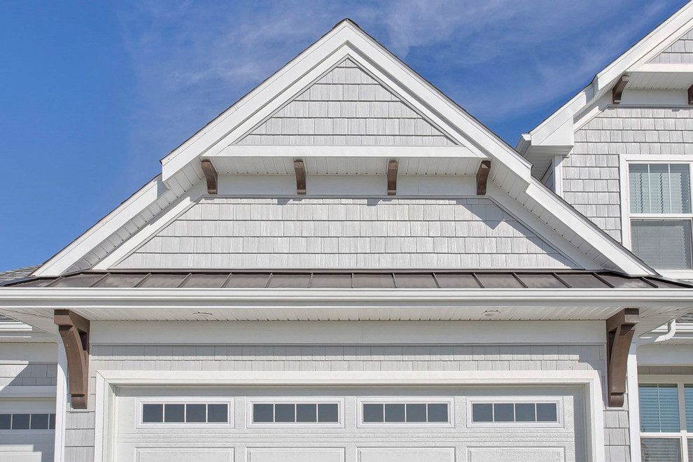 Example of a mid-sized transitional gray two-story vinyl exterior home design in Chicago with a hip roof