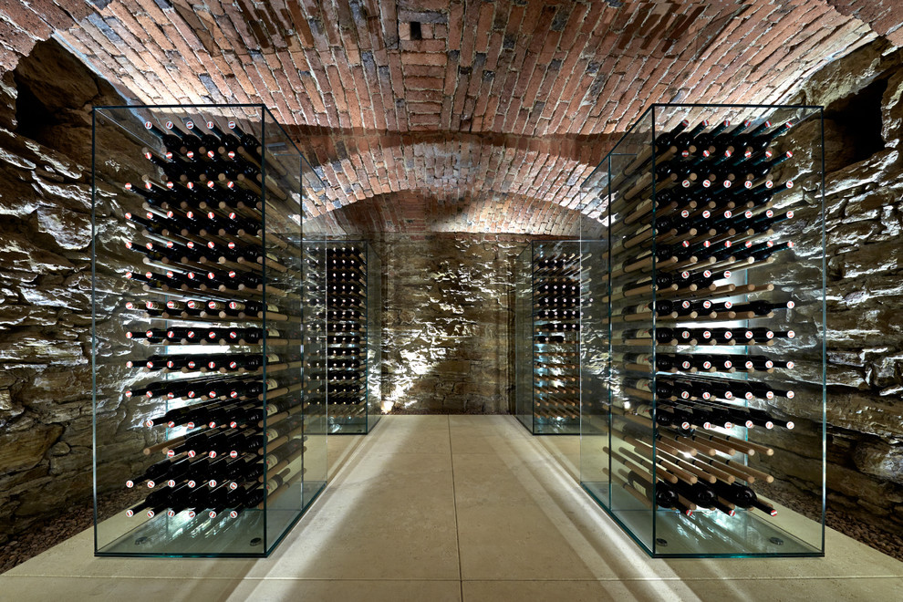 Inspiration for a mid-sized country wine cellar in Other with storage racks and beige floor.