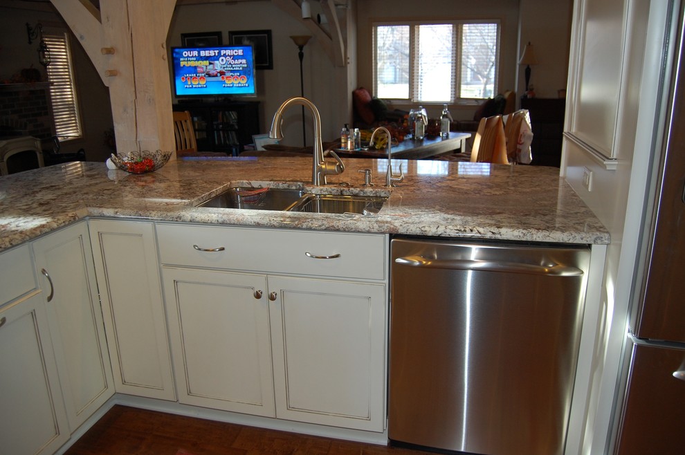 Open concept kitchen - mid-sized transitional u-shaped medium tone wood floor open concept kitchen idea in Chicago with an undermount sink, flat-panel cabinets, dark wood cabinets, granite countertops, beige backsplash, stone tile backsplash, stainless steel appliances and a peninsula