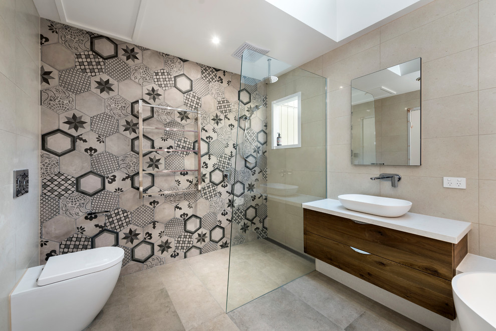 Inspiration for a large contemporary bathroom in Melbourne with flat-panel cabinets, brown cabinets, a one-piece toilet, multi-coloured tile, multi-coloured walls, a vessel sink, beige floor, an open shower, white benchtops and an open shower.