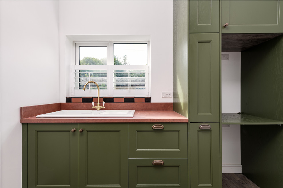 Inspiration for a large traditional laundry room in Kent with shaker cabinets and green cabinets.