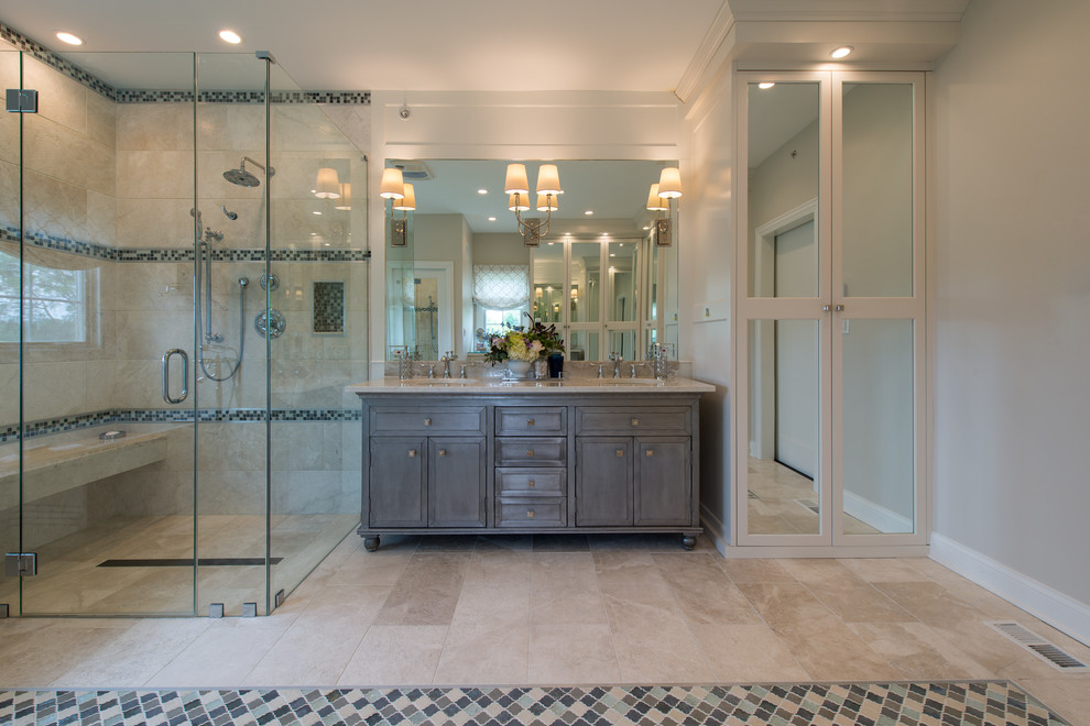 Inspiration for a transitional master beige tile and stone tile limestone floor freestanding bathtub remodel in Chicago with shaker cabinets, beige cabinets, a two-piece toilet, beige walls, an undermount sink and marble countertops