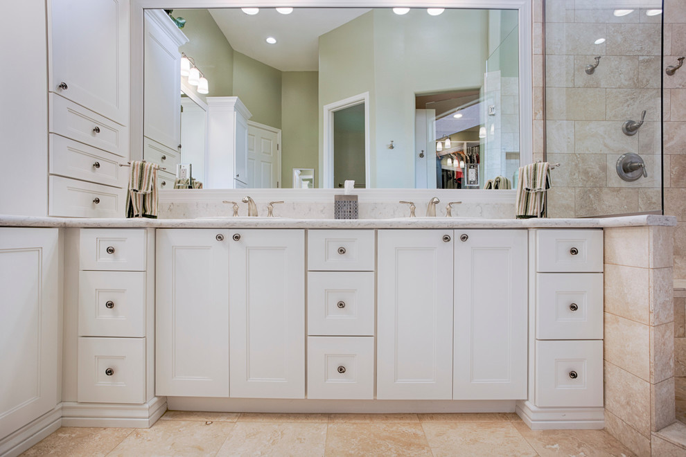Inspiration for a large transitional master beige tile and travertine tile travertine floor corner shower remodel in Phoenix with recessed-panel cabinets, white cabinets, green walls, an undermount sink and granite countertops