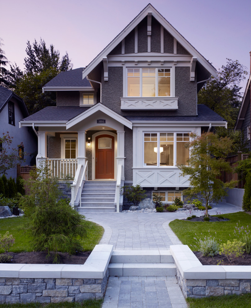 This is an example of a mid-sized arts and crafts two-storey grey exterior in Vancouver with a gable roof.