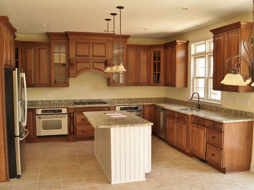 Design ideas for a large traditional u-shaped open plan kitchen in Other with an undermount sink, raised-panel cabinets, medium wood cabinets, granite benchtops, stainless steel appliances, ceramic floors and with island.