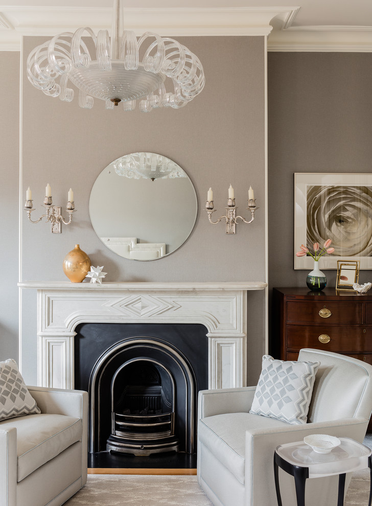 Inspiration for a large traditional living room in Boston with grey walls, light hardwood floors, a standard fireplace, a stone fireplace surround and grey floor.