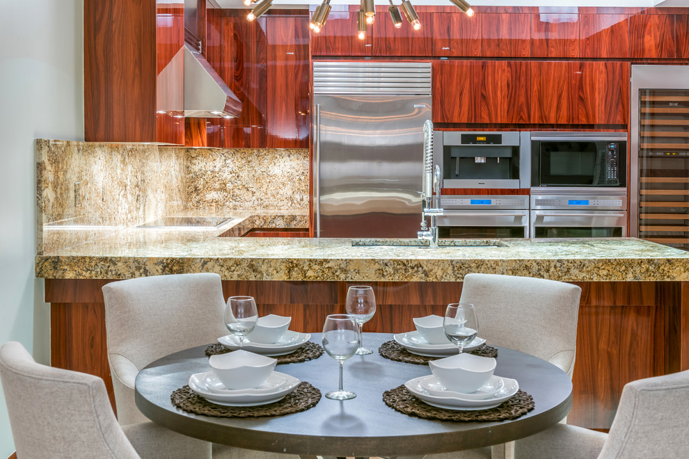 Design ideas for a transitional kitchen in Miami with an undermount sink, flat-panel cabinets, medium wood cabinets, granite benchtops, multi-coloured splashback, stone slab splashback, stainless steel appliances, marble floors and a peninsula.