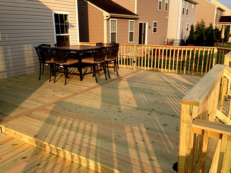 Deck - mid-sized craftsman backyard ground level wood railing deck idea in Cleveland with no cover