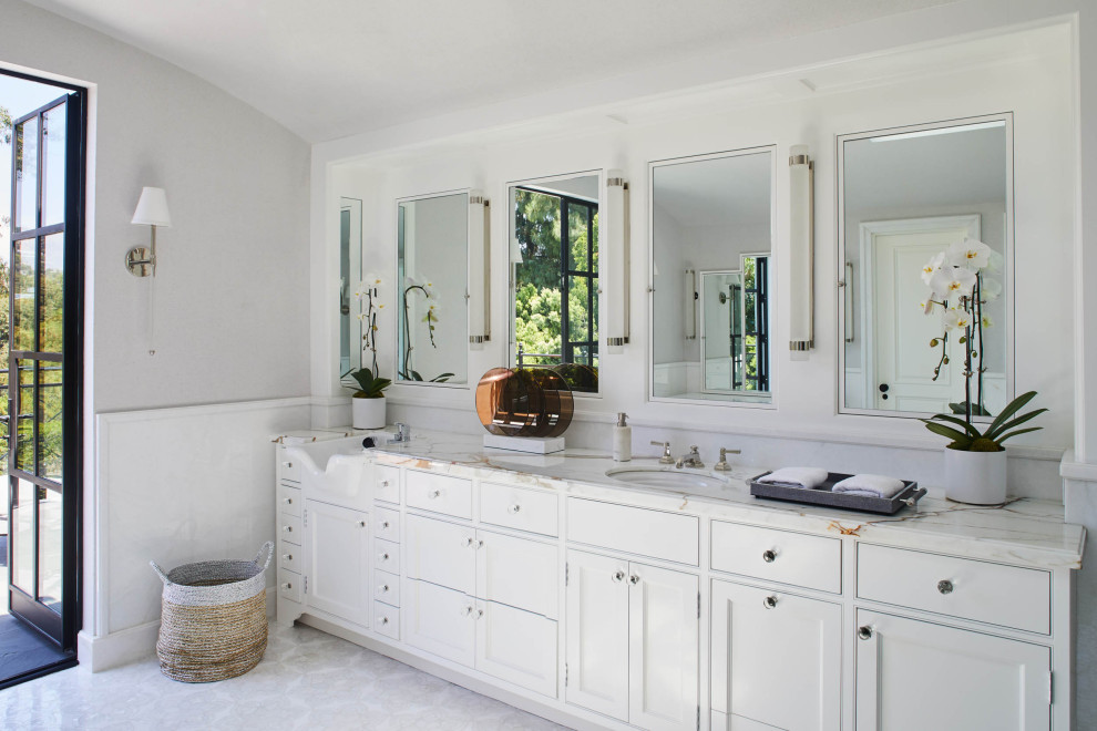 Photo of a large classic ensuite bathroom in Los Angeles with white tiles, marble tiles, grey walls, beige floors, white cabinets, a submerged sink, marble worktops, white worktops, double sinks and a built in vanity unit.