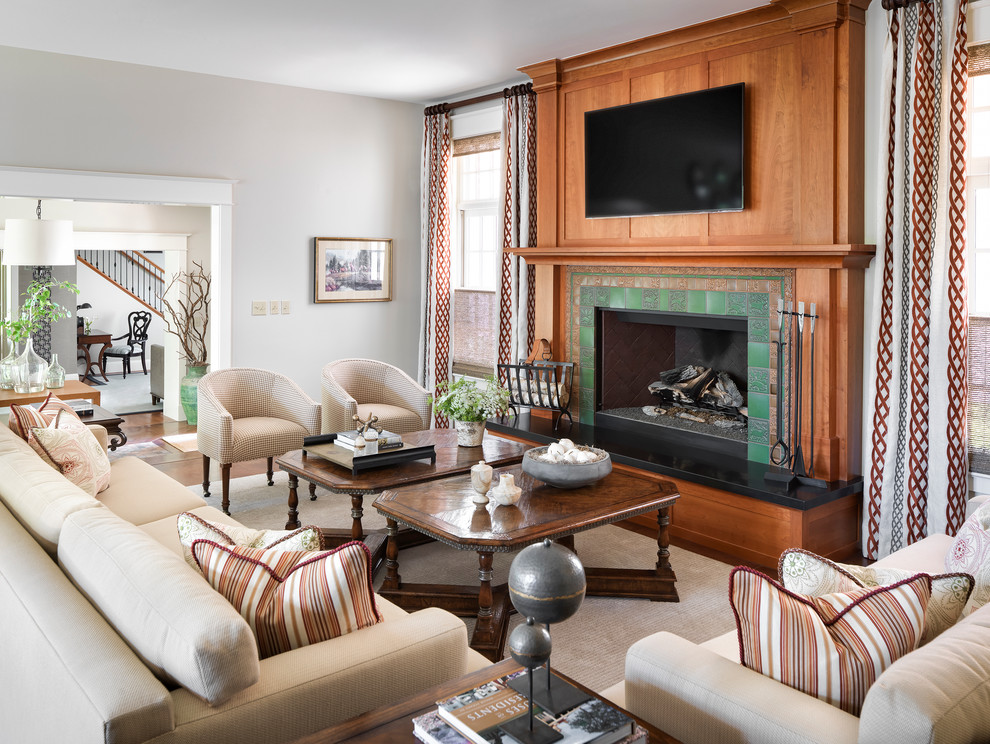 Inspiration for a mid-sized traditional enclosed living room in Denver with grey walls, dark hardwood floors, a standard fireplace, a tile fireplace surround, a wall-mounted tv and brown floor.