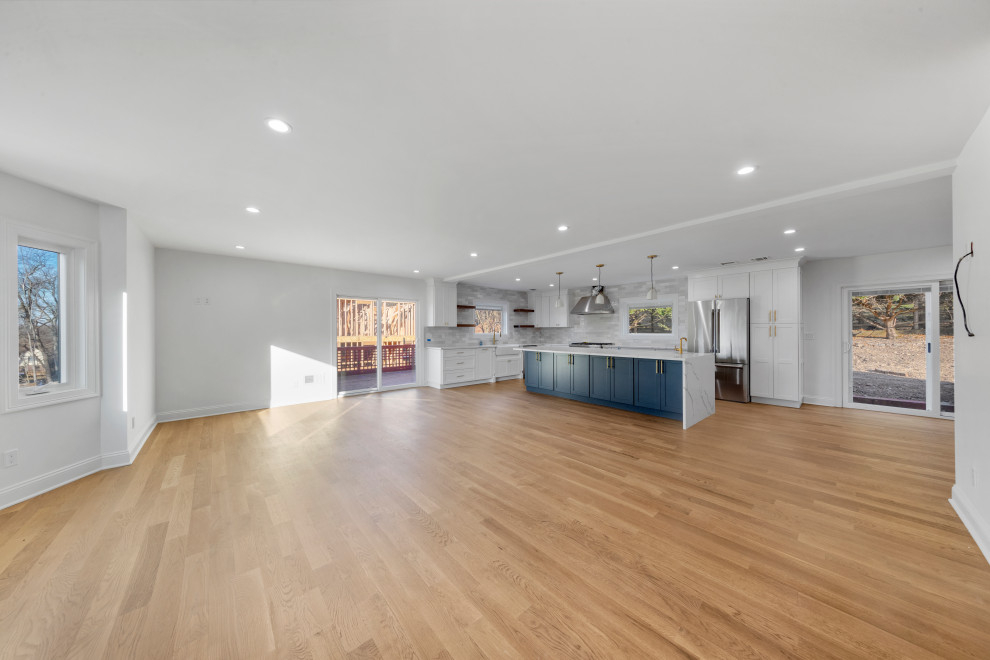 Open-Plan Kitchen with Navy Island and White Cabinetry