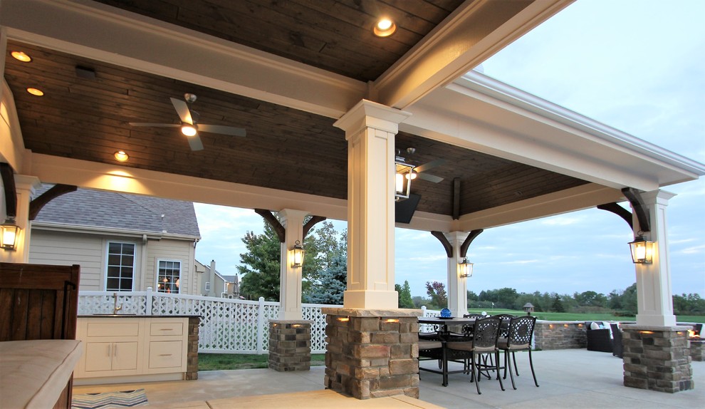 Home design - large transitional backyard concrete home design idea with a roof extension