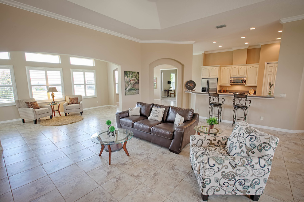 This is an example of a mid-sized traditional open concept living room in Orlando with beige walls and ceramic floors.
