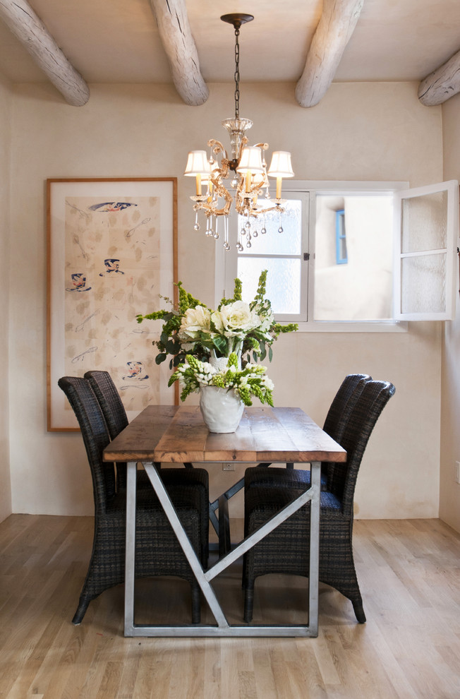 Mediterranean dining room in Albuquerque with beige walls and light hardwood floors.