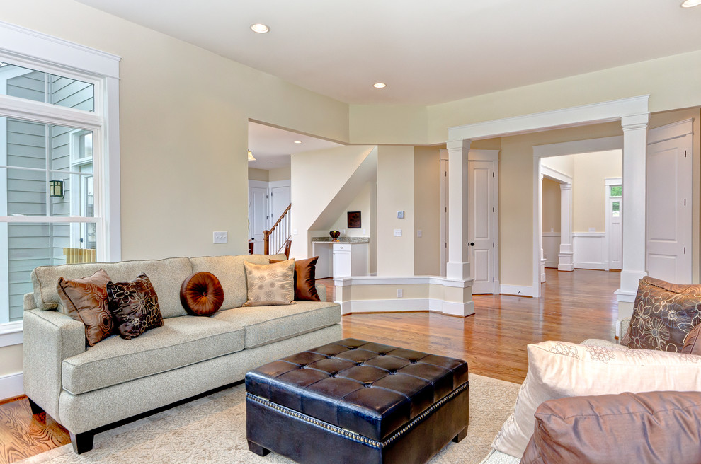 Arts and crafts open concept family room in DC Metro with medium hardwood floors.