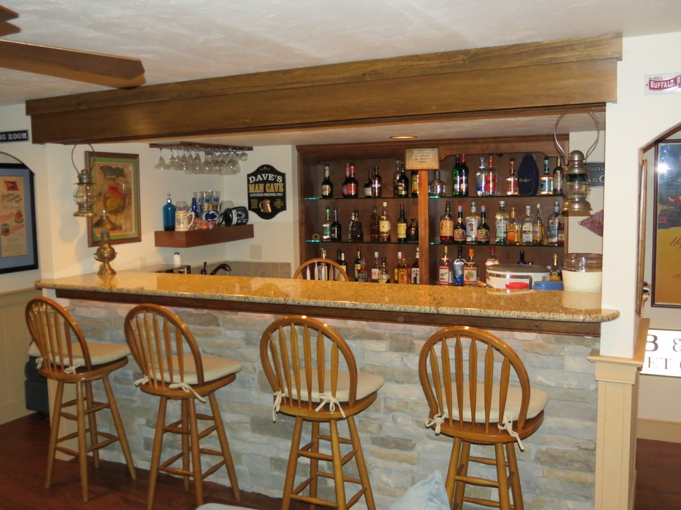 Inspiration for a small timeless medium tone wood floor home bar remodel in Other