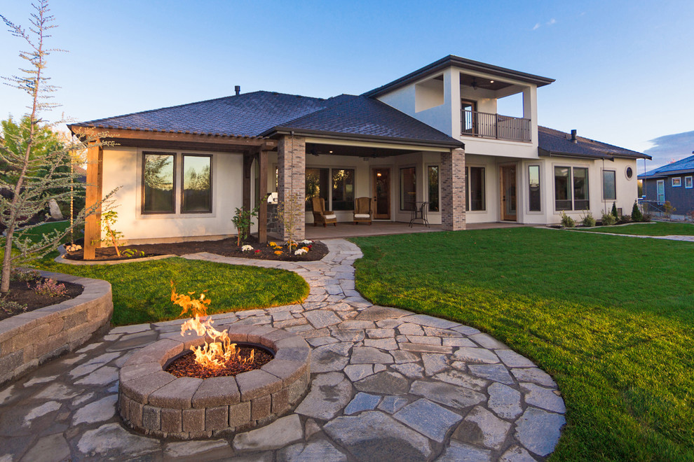 Photo of a large contemporary backyard patio in Boise with a fire feature, natural stone pavers and no cover.