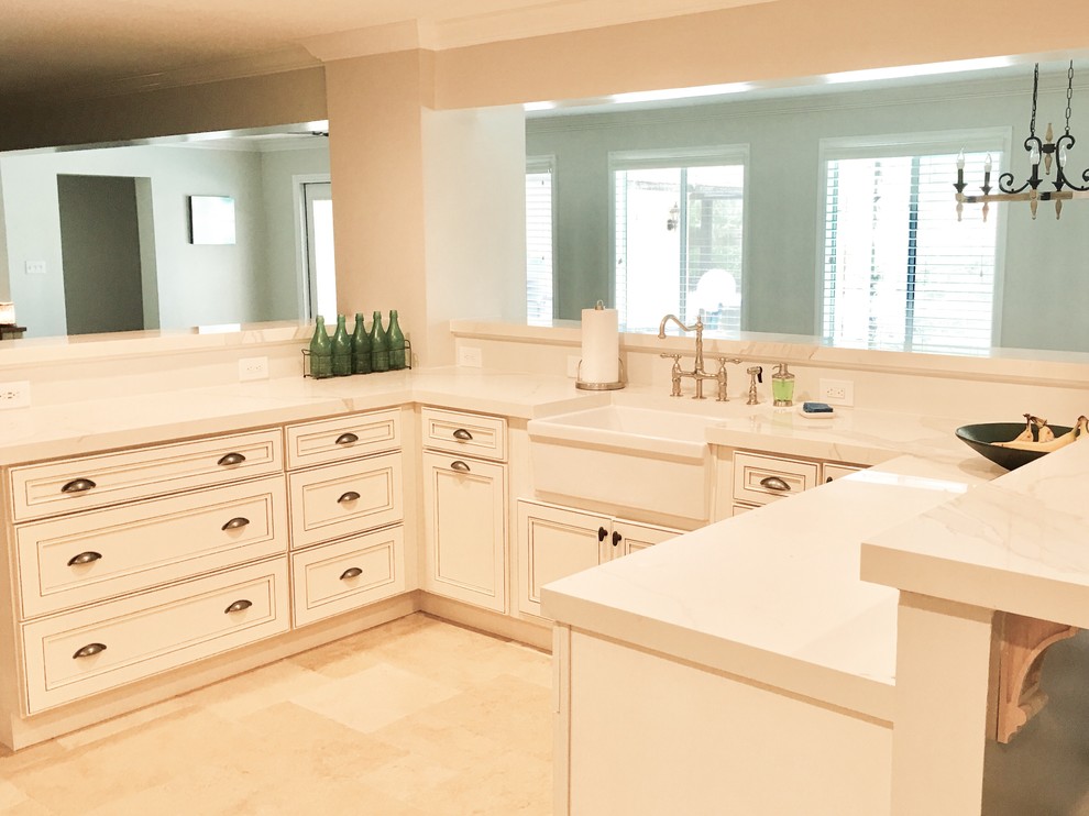 This is an example of a large contemporary u-shaped open plan kitchen in Orlando with a farmhouse sink, recessed-panel cabinets, white cabinets, marble benchtops, white splashback, subway tile splashback, stainless steel appliances, slate floors and a peninsula.
